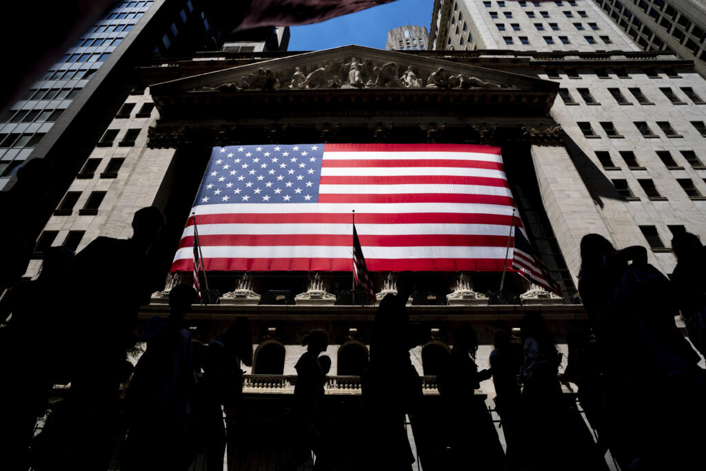 People walk past the New York Stock Exchange on Wednesday, June 29, 2022 in New York.   Wall Street is making only modest moves following a hotly anticipated report on inflation Tuesday, Feb.