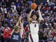 Gonzaga guard Julian Strawther (0) shoots while defended by San Diego guard Dominic Muncey (32) during the second half of an NCAA college basketball game Thursday, Feb. 23, 2023, in Spokane, Wash. Gonzaga won 97-72.