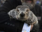 Groundhog Club handler A.J. Dereume holds Punxsutawney Phil, the weather prognosticating groundhog, during the 137th celebration of Groundhog Day on Gobbler's Knob in Punxsutawney, Pa., Thursday, Feb. 2, 2023. Phil's handlers said that the groundhog has forecast six more weeks of winter.