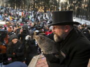 Groundhog Club handler A.J. Dereume holds Punxsutawney Phil, the weather prognosticating groundhog, during the 137th celebration of Groundhog Day on Gobbler's Knob in Punxsutawney, Pa., Thursday, Feb. 2, 2023. Phil's handlers said that the groundhog has forecast six more weeks of winter.