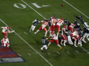 Kansas City Chiefs place kicker Harrison Butker (7) kicks the game-winning field goal as punter Tommy Townsend (5) holds during the second half of the NFL Super Bowl 57 football game against the Philadelphia Eagles, Sunday, Feb. 12, 2023, in Glendale, Ariz.