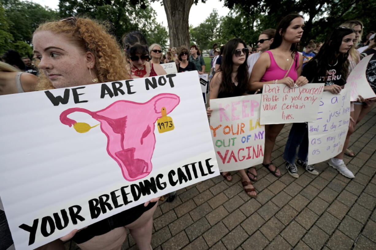 FILE - Abortion-rights advocates gather outside a the Kansas Statehouse to protest the U.S. Supreme Court's ruling on abortion, June 24, 2022, in Topeka, Kan. The Republican-controlled Kansas Legislature is considering millions of dollars in state funds for centers that provide pregnancy tests, sonograms and counseling in an effort to keep women from having abortions. Also on the table: millions more in income tax credits to their donors.