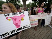 FILE - Abortion-rights advocates gather outside a the Kansas Statehouse to protest the U.S. Supreme Court's ruling on abortion, June 24, 2022, in Topeka, Kan. The Republican-controlled Kansas Legislature is considering millions of dollars in state funds for centers that provide pregnancy tests, sonograms and counseling in an effort to keep women from having abortions. Also on the table: millions more in income tax credits to their donors.