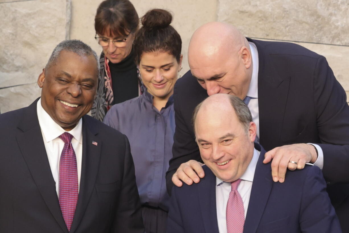 United States Secretary of Defense Lloyd Austin, Portugal's Defense Minister Helena Carreiras, Iceland's Defense Minister Thordis Kolbrun Reykfjord Gylfadottir, British Defense Secretary Ben Wallace and Italy's Defense Minister Guido Crosetto, from left to top right, laugh during a group photo of NATO defense ministers at NATO headquarters in Brussels, Wednesday, Feb. 15, 2023.