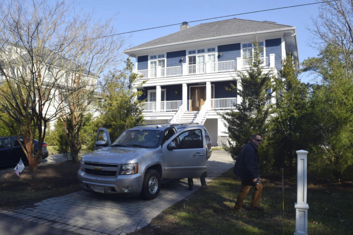 FILE - U.S. Secret Service agents are seen in front of Joe Biden's Rehoboth Beach, Del., home on Jan. 12, 2021. The FBI is conducting a planned search of President Joe Biden's Rehoboth Beach, Delaware home as part of its investigation into the potential mishandling of classified documents. That's according to a statement from Biden's personal lawyer.