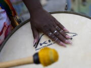 A member of the Turma da Paz de Madureira, or TPM, samba school plays a drum during a rehearsal in preparation for Rio's Carnival parade, in Rio de Janeiro, Brazil, Saturday, Feb. 4, 2023. TPM is the first all-female samba school in Rio.