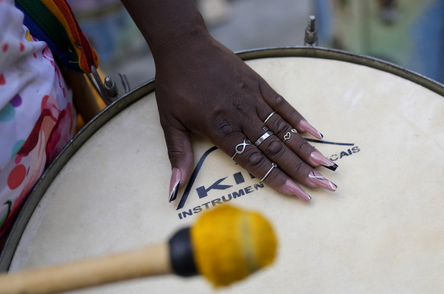 A member of the Turma da Paz de Madureira, or TPM, samba school plays a drum during a rehearsal in preparation for Rio's Carnival parade, in Rio de Janeiro, Brazil, Saturday, Feb. 4, 2023. TPM is the first all-female samba school in Rio.