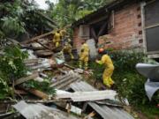 Rescue workers search for survivors after flooding triggered deadly landslides near Juquehy beach in Sao Sebastiao, Brazil, Monday, Feb. 20, 2023.