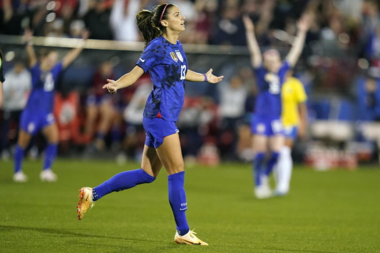 United States forward Alex Morgan (13) reacts to scoring a goal during the first half of a SheBelieves Cup soccer match against Brazil Wednesday, Feb. 22, 2023, in Frisco, Texas.