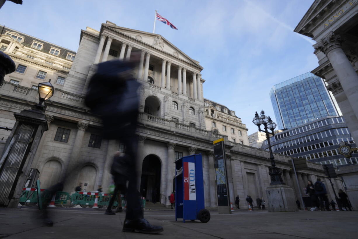 People walk past the Bank of England in London, Thursday, Feb. 2, 2023. The Bank of England is expected to raise interest rates by as much as half a percentage point. That would outpace the latest hike by the U.S. Federal Reserve. The move on Thursday comes as the central bank seeks to tame decades-high inflation that has driven a cost-of-living crisis and predictions of recession.