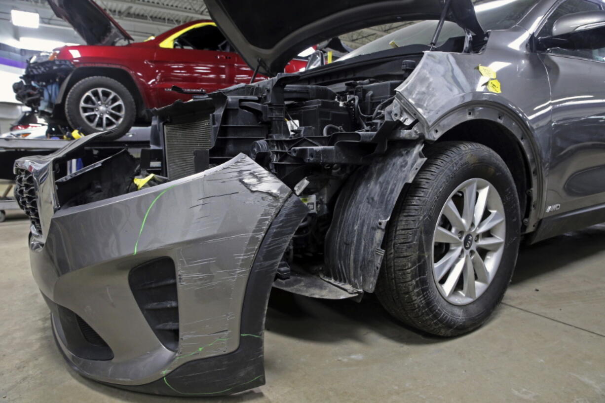 FILE - A Kia which was damaged after being stolen is seen at an auto repair shop in Milwaukee on Wednesday, Jan. 27, 2021.  Automakers Hyundai and Kia are offering software updates for millions of their vehicles that are missing a "key" anti-theft device, an issue that was exploited on social media and led to rampant theft of the cars. The National Highway Traffic Safety Administration said Tuesday, Feb. 14, 2023 that the software updates the theft alarm software logic to extend the length of the alarm sound from 30 seconds to one minute and requires the key to be in the ignition switch to turn the vehicle on.