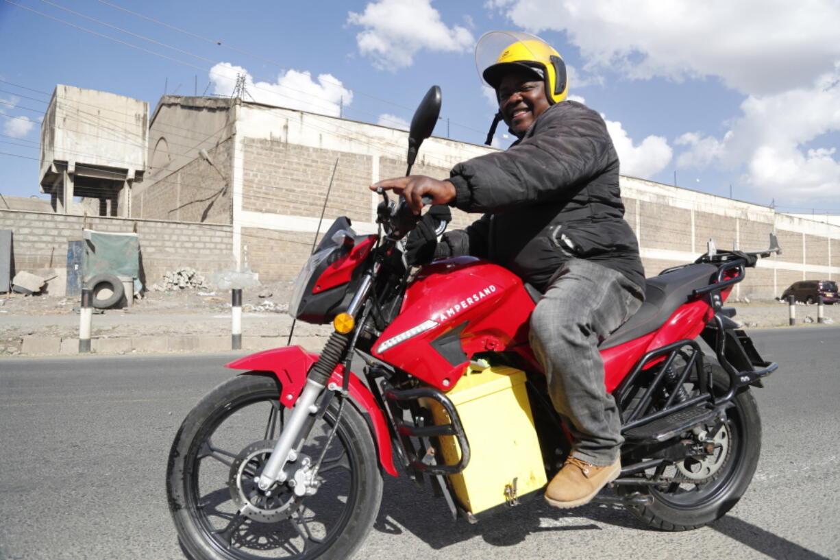 A man rides an electric motorcycle from Ampersand on a test drive in Nairobi, Kenya, Jan. 23, 2023. Electric motorcycles are gaining traction in Kenya as private sector-led firms rush to set up charging points and battery-swapping stations to speed up the growth of cleaner transport and put the east African nation on a path toward fresher air and lower emissions.