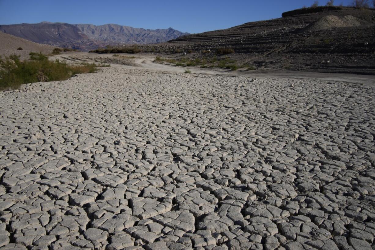 Cracked earth is visible in an area once under the water of Lake Mead at the Lake Mead National Recreation Area, Friday, Jan. 27, 2023, near Boulder City, Nev. Amid a major drought in the Western U.S., a proposed solution comes up repeatedly: large-scale river diversions, including pumping Mississippi River water to parched states.