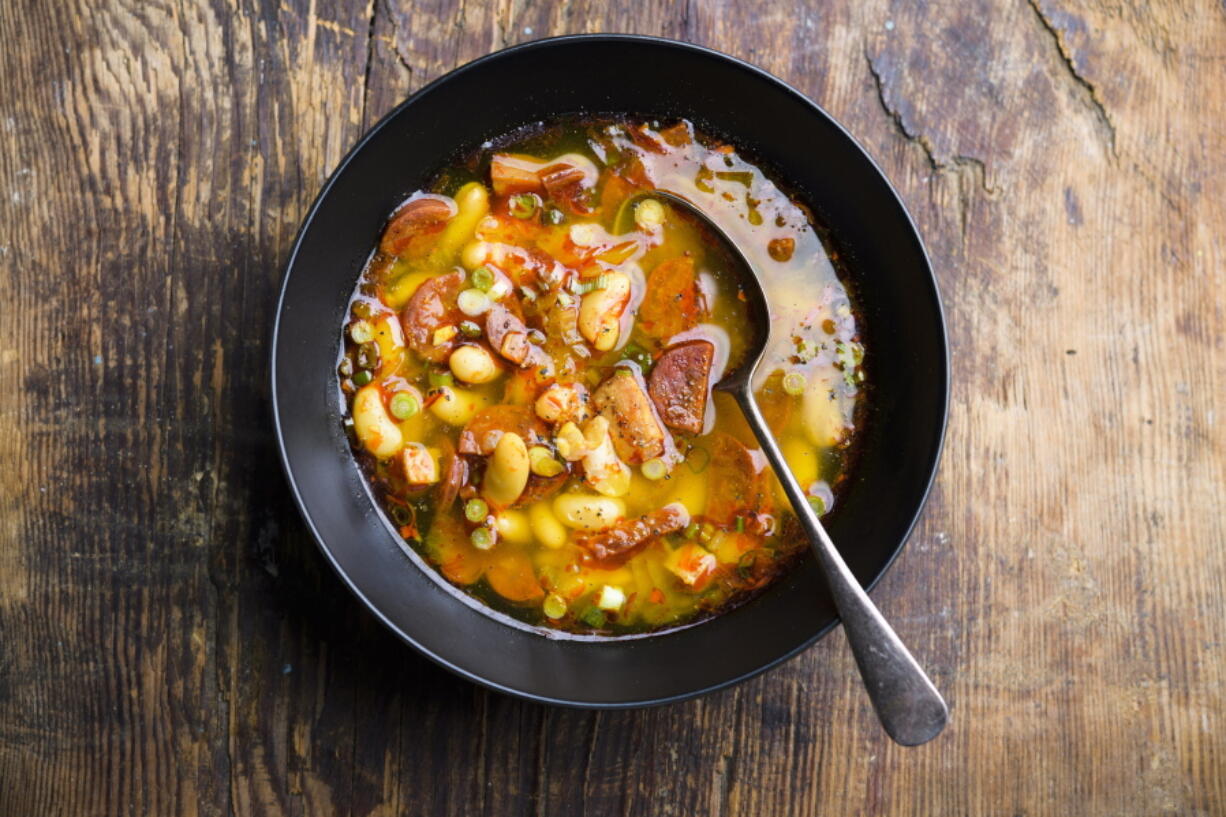 This image released by Milk Street shows a recipe for Spanish Chorizo, Ham and White Bean Stew.