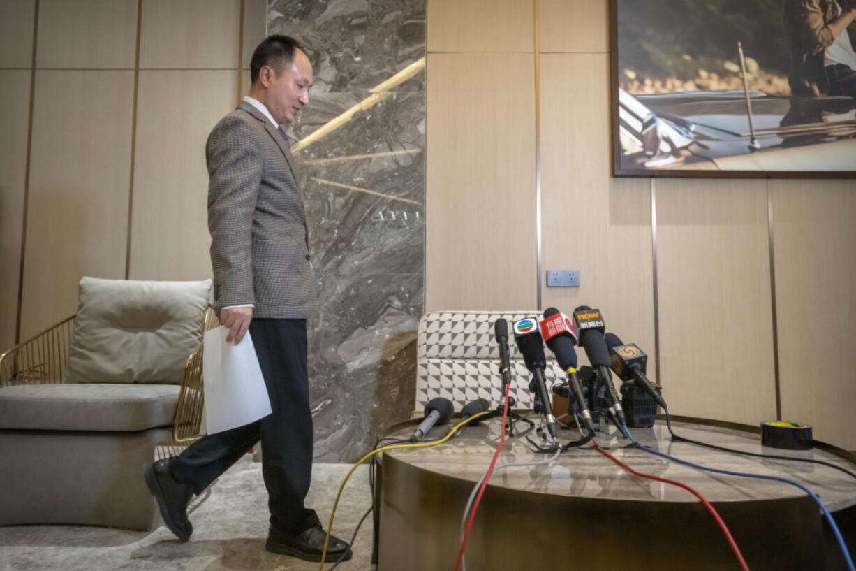 FILE - Chinese scientist He Jiankui arrives to speak at a brief press conference in Beijing on Feb. 21, 2023. He, a Chinese scientist who set off an ethical debate five years ago with claims that he made the world's first genetically edited babies, said that he hopes to research rare hereditary diseases in Hong Kong.