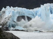 FILE - Chunks of ice break off the Perito Moreno Glacier, in Lake Argentina, at Los Glaciares National Park, near El Calafate, in Argentina's Patagonia region, March 10, 2016. As glaciers melt and pour massive amounts of water into nearby lakes, 15 million people across the globe live under the threat of a sudden and deadly outburst flood, a new study finds.