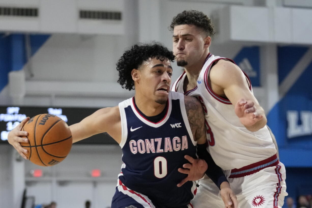 Gonzaga guard Julian Strawther (0) controls the ball against Loyola Marymount forward Alex Merkviladze (23) during the first half of an NCAA college basketball game in Los Angeles, Thursday, Feb. 16, 2023.