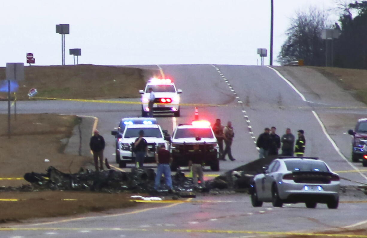 Law enforcement work at the scene of a Black Hawk helicopter crash Wednesday, Feb. 15, 2023, in the unincorporated community of Harvest, Ala. U.S. military officials say two people on board the helicopter, which was from the Tennessee National Guard, were killed.