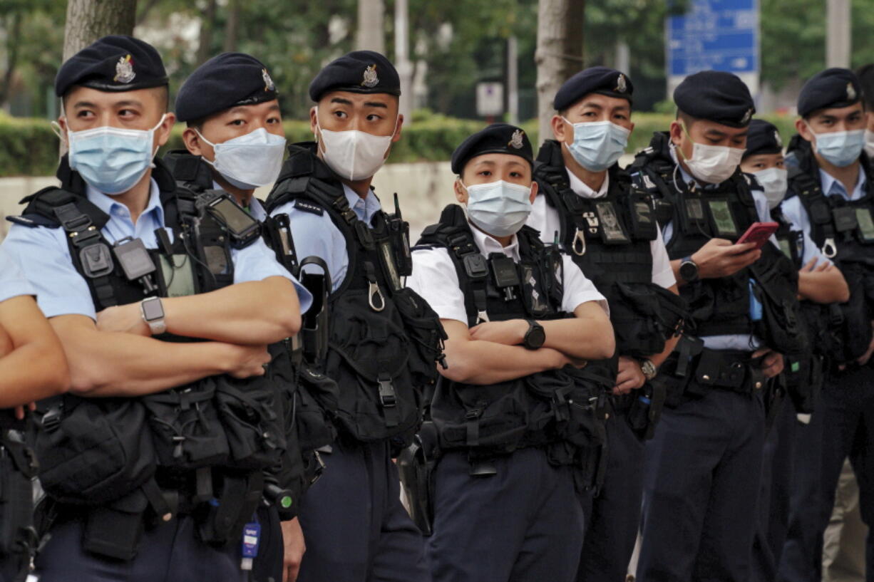 Policemen wearing face masks stand guard outside the West Kowloon Magistrates' Courts ahead of the national security trail for the pro-democracy activists in Hong Kong, Monday Feb. 6, 2023. Some of Hong Kong's best-known pro-democracy activists went on trial Monday in the biggest prosecution yet under a law imposed by China's ruling Communist Party to crush dissent.