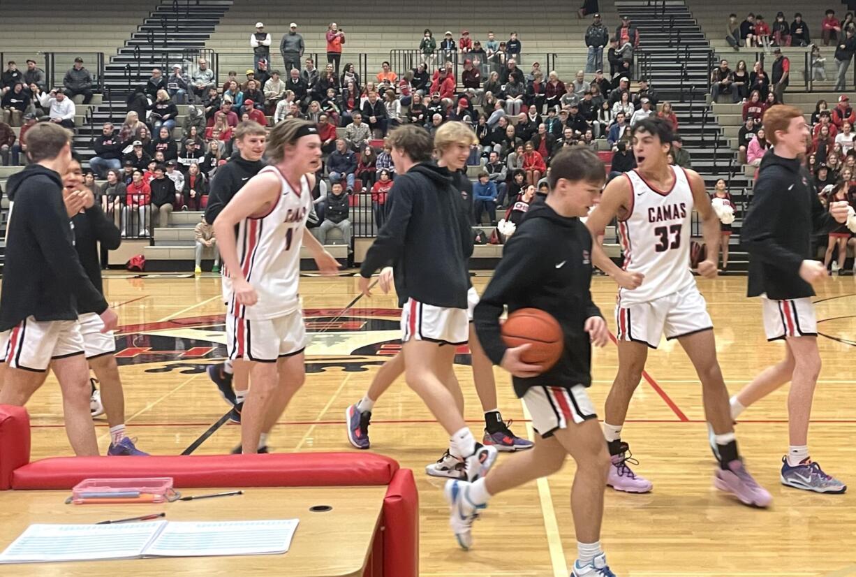 Camas players walk to the bench prior to the start of the team's 4A bi-district playoff game against Bellarmine Prep on Saturday, Feb. 11, 2023, at Camas High School.