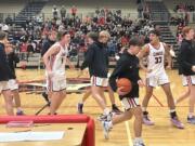 Camas players walk to the bench prior to the start of the team's 4A bi-district playoff game against Bellarmine Prep on Saturday, Feb. 11, 2023, at Camas High School.