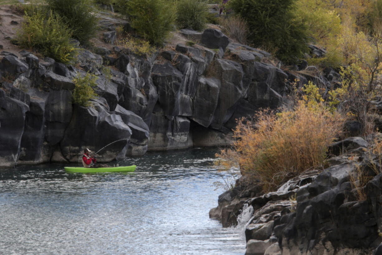 FILE - A man hooks a fish on the Snake River in Idaho Falls, Idaho on Sunday, Oct. 11, 2020. Idaho has joined a Texas lawsuit against the Biden administration waterway protections, claiming the rules are too vague and violate state sovereignty rights. The lawsuit was originally filed in southern Texas' federal courts Jan. 18, 2023. It was amended to include Idaho on Monday, Feb. 27.