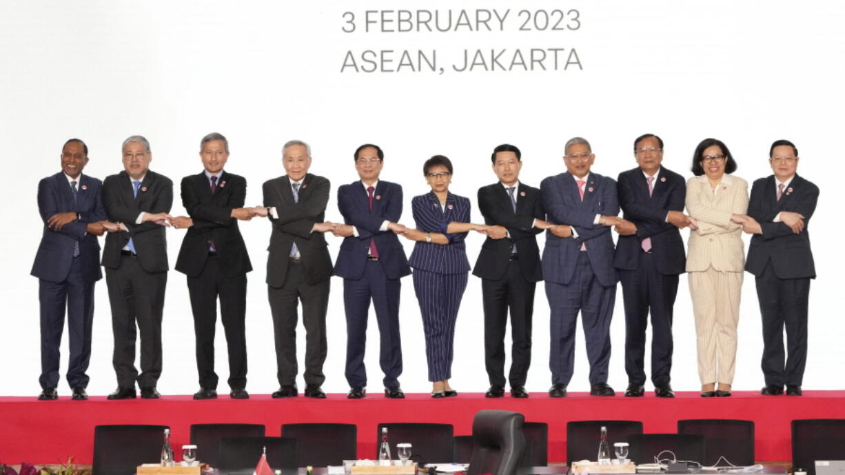 From left to right; Malaysian Foreign Minister Zambry Abdul Kadir, Philippine's Foreign Secretary Enrique Manalo, Singaporean Foreign Minister Vivian Balakrishnan, Thailand's Foreign Minister Don Pramudwinai, Vietnam's Foreign Minister Bui Thanh Son, Indonesian Foreign Minister Retno Marsudi, Laotian Foreign Minister Saleumxay Kommasith, Brunei's Second Minister of Foreign Affair Erywan Yusof, Cambodia's Foreign Minister Prak Sokhonn, East Timor's Foreign Minister Adaljiza Magno and ASEAN Secretary General Kao Kim Hourn hold hands as they pose for a group photo during the Association of Southeast Asian Nations (ASEAN) Coordinating Council Meeting at the ASEAN Secretariat in Jakarta, Indonesia, Friday, Feb. 3, 2023. Southeast Asian foreign ministers are meeting in Indonesia's capital Friday for talks bound to be dominated by the deteriorating situation in Myanmar despite an agenda focused on food and energy security and cooperation in finance and health.