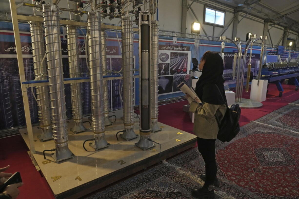 A student looks at Iran's domestically built centrifuges in an exhibition of the country's nuclear achievements, in Tehran, Iran, Wednesday, Feb. 8, 2023. The head of the United Nations nuclear watchdog on Tuesday underscored the urgency of resuscitating diplomatic efforts to limit Iran's nuclear program, saying the situation could quickly worsen if negotiations fail.