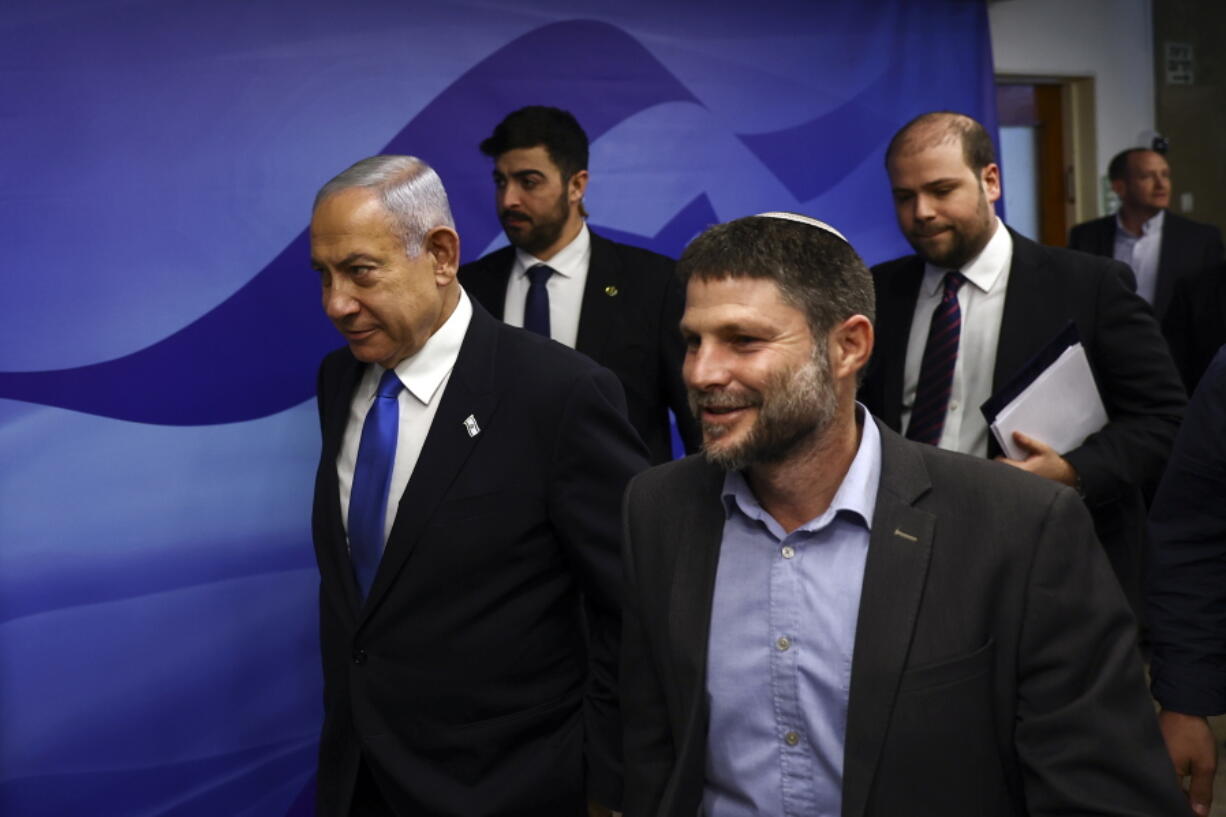 Israeli Prime Minister Benjamin Netanyahu, left, and Finance Minister Bezalel Smotrich, right, arrive to attend a cabinet meeting at the Prime Minister's office in Jerusalem, Thursday, Feb. 23, 2023.