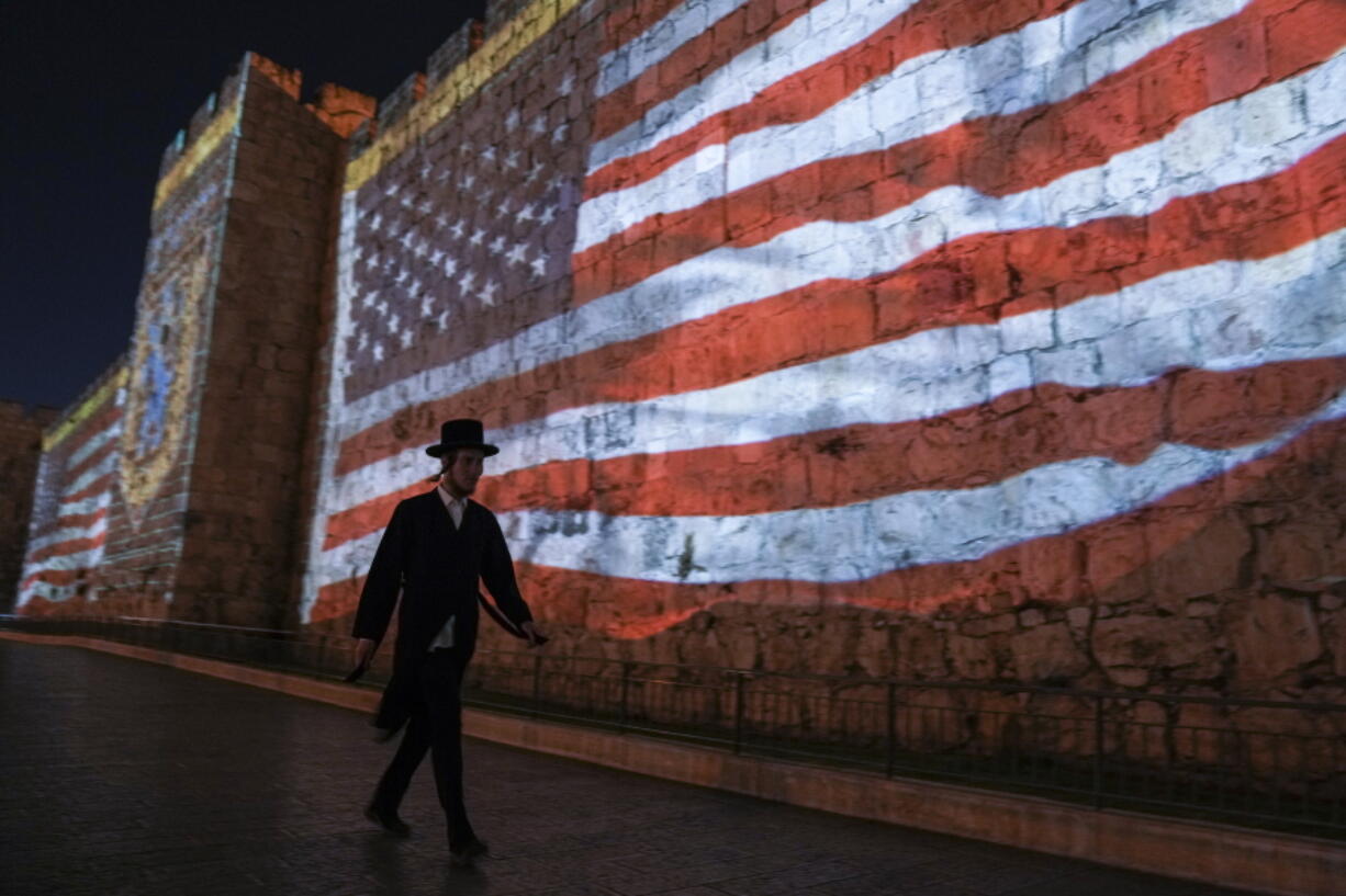 FILE - An image of the U.S. flag is projected on the walls of Jerusalem's Old City in honor of President Joe Biden's visit to Jerusalem, Wednesday, July 13, 2022. Several U.S. Jewish leaders are sounding alarms about what they see as a threat to Israel's democracy posed by its new government, the Likud party led by Benjamin Netanyahu who took office in December 2022, fearing it will erode the independence of its judiciary and legal protections for minority groups.