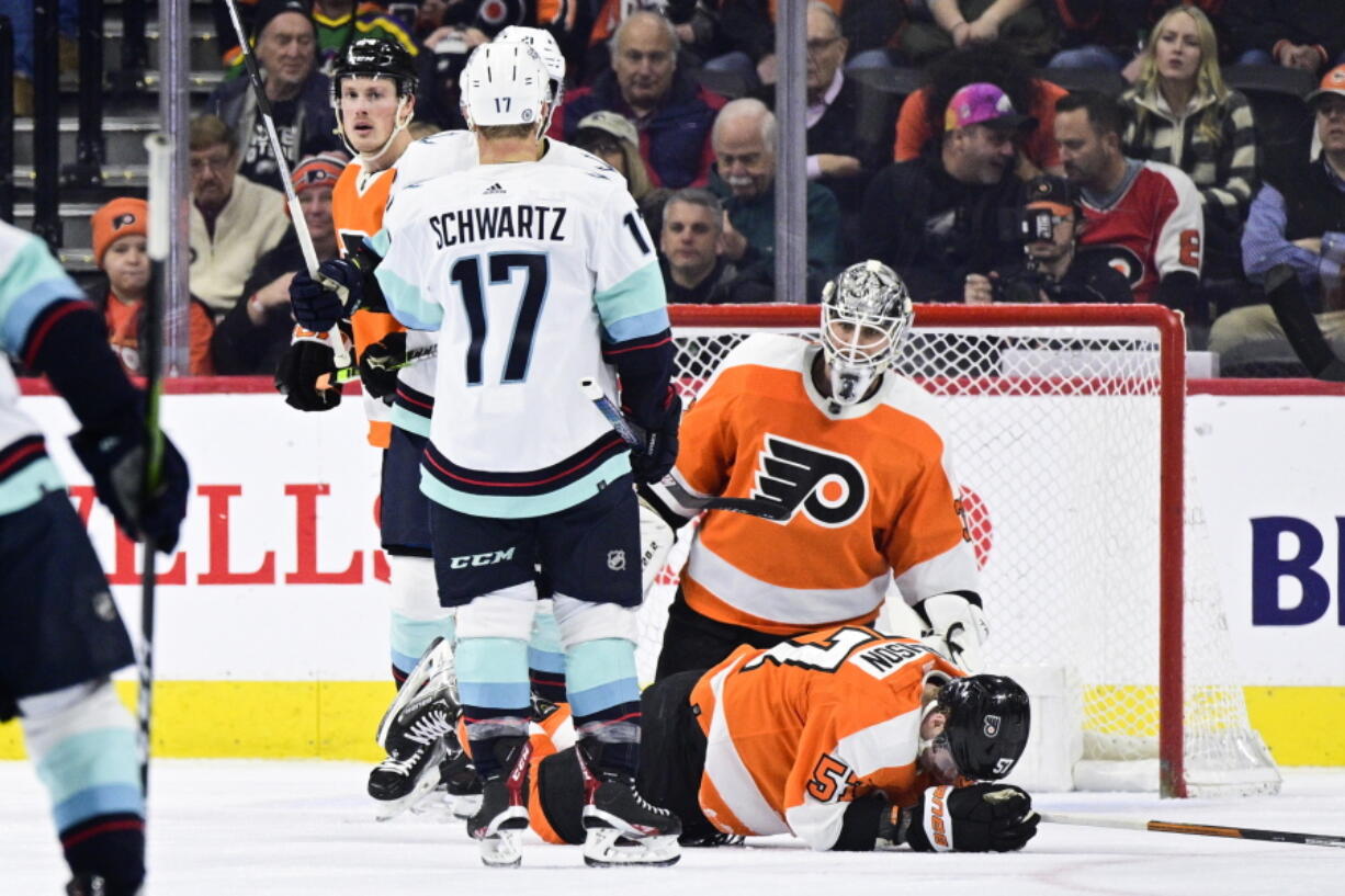 Seattle Kraken's Jaden Schwartz (17) celebrates with teammate Alex Wennberg after scoring a goal past Philadelphia Flyers goaltender Felix Sandstrom (32) during the second period an NHL hockey game, Sunday, Feb. 12, 2023, in Philadelphia.