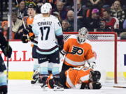 Seattle Kraken's Jaden Schwartz (17) celebrates with teammate Alex Wennberg after scoring a goal past Philadelphia Flyers goaltender Felix Sandstrom (32) during the second period an NHL hockey game, Sunday, Feb. 12, 2023, in Philadelphia.