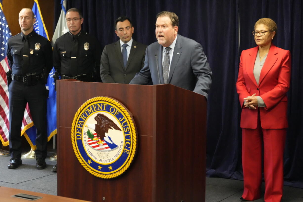 Jeffrey Abrams, Regional Director of Anti-Defamation League, ADL Los Angeles, at podium, denounces anti-Semitism and hate crimes at a news conference at the U.S. Attorney's Office Central District of California offices in Los Angeles Friday, Feb. 17, 2023. From left, United States Attorney Martin Estrada and Los Angeles Mayor Karen Bass. A person was taken into custody Thursday in connection with the shootings of two Jewish men outside synagogues in Los Angeles this week that investigators believe were hate crimes, police said.