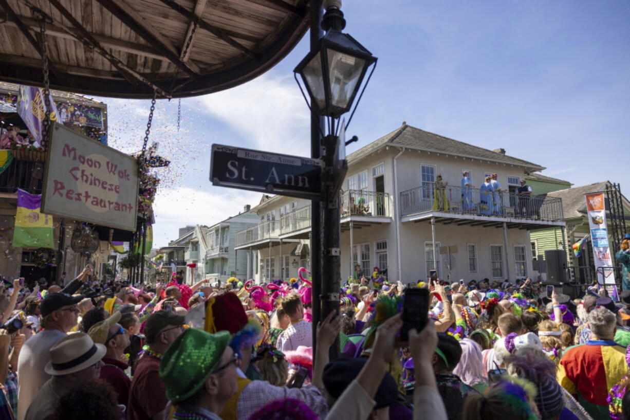 FILE - A crowd of people attend the Bourbon Street Awards costume contest on Tuesday, March 1, 2022, in the French Quarter of New Orleans on Mardi Gras.  The buildup to New Orleans' Mardi Gras celebration intensifies Friday, Feb. 10, 2023, with nighttime parades rolling along St. Charles Avenue and animal lovers gathering at Galatoire's Restaurant to pay tribute to four-legged faux royalty.