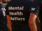 FILE - Stanford women's soccer team players wear warmup jerseys with "Mental Health Matters" on their backs as well as a butterfly patch on their sleeves to remember late goalie Katie Meyer, who died by suicide earlier in the year, before an NCAA college soccer match against UCLA, Oct. 14, 2022, in Stanford, Calif. The COVID-19 pandemic took an especially harsh toll on U.S. teen girls' mental health, with almost 60% reporting feelings of persistent sadness or hopelessness, according to a government survey released Monday, Feb. 13, 2023, that bolsters earlier data. (Yalonda M.