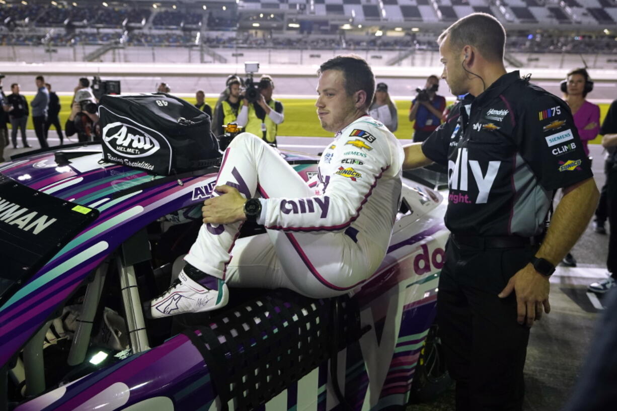 Alex Bowman climbs out of his car during his qualifying run for the NASCAR Daytona 500 auto race Wednesday, Feb. 15, 2023, at Daytona International Speedway in Daytona Beach, Fla. Bowman took the pole position for Sunday's race.