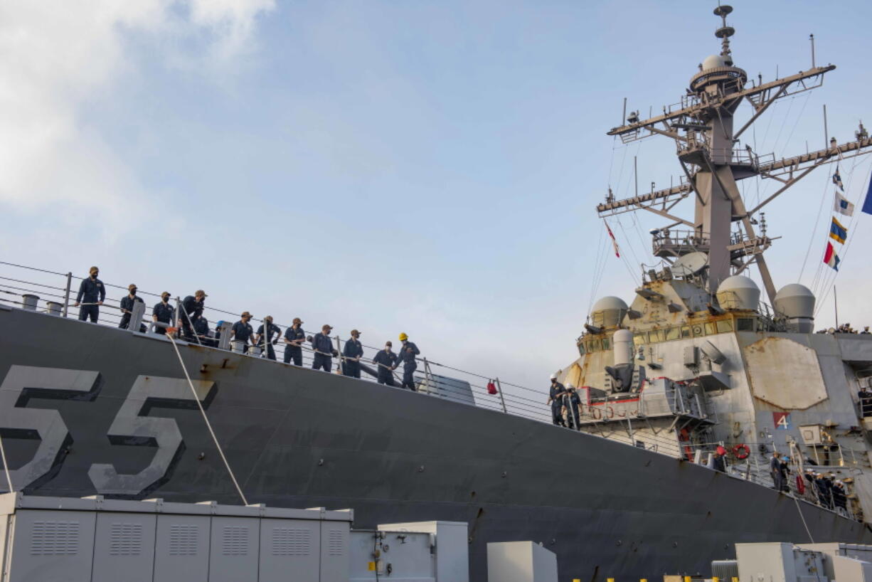 FILE - In this photo provided by the U.S. Navy, sailors aboard the guided missile destroyer USS Stout handle mooring lines during the ship's return to home port at Naval Station Norfolk, in Norfolk, Va., in this Oct. 12, 2020, photo.  Navy ships are getting fewer steaming hours because of growing maintenance delays and costs, a troubling trend that comes as at time when the U.S. is struggling to keep pace with China's growing fleet. (Spc. Jason Pastrick/U.S.