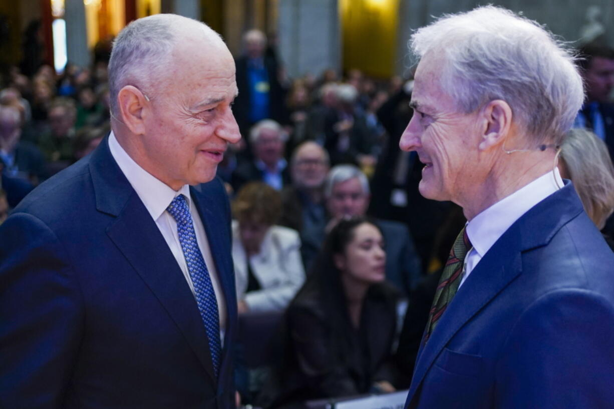 NATO's Deputy Secretary General Mircea Geoana, left, and Norway's Prime Minister Jonas Gahr Store, speak at the Leangkollen Security Conference 2023 in the university hall in Oslo, Norway, Monday, Feb. 6, 2023.