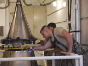 In this image provided by the U.S. Air Force, Senior Airmen Andrew Whitener and Tyler Glodgett 341st Missile Maintenance Squadron topsiders, inspect the cable connections of an intercontinental ballistic missile during a Simulated Electronic Launch-Minuteman test Sept. 22, 2020, at a launch facility near Great Falls, Mont. The top Air Force officer in charge of the nation's air and ground-launched nuclear missiles has requested an official investigation into the number of officers who are reporting the same type of blood cancer after serving at Malmstrom Air Force Base. (Tristan Day/U.S.