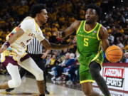 Oregon's Jermaine Couisnard (5) drives around Arizona State's Desmond Cambridge Jr. (4) during the first half of an NCAA college basketball game, Saturday, Feb. 4, 2023, in Tempe, Ariz.