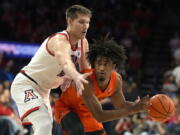 Oregon State forward Glenn Taylor Jr., right, shields the ball from Arizona forward Azuolas Tubelis during the first half of an NCAA college basketball game, Saturday, Feb. 4, 2023, in Tucson, Ariz.