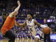 Washington guard Jamal Bey drives against Oregon State forward Dzmitry Ryuny during the first half of an NCAA collage basketball game, Saturday, Feb. 18, 2023, in Seattle.