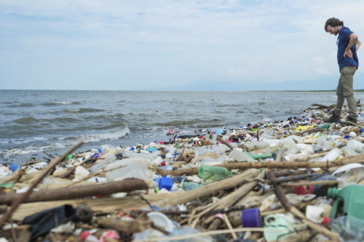 This photo provided by The Ocean Cleanup shows The Ocean Cleanup's founder and CEO Boyan Slat among the trash on the Rio Motagua in Guatemala in 2022.