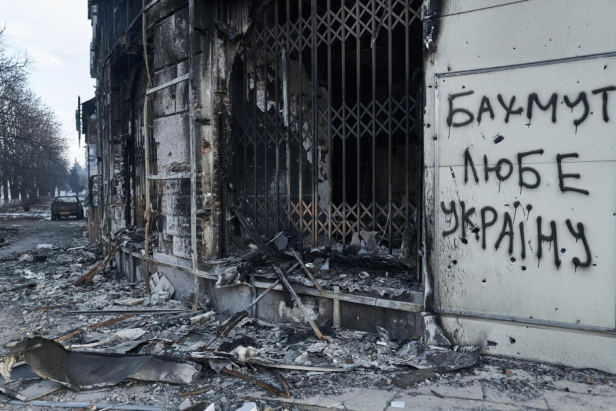 The city center damaged by Russian shelling in Bakhmut, Donetsk region, Ukraine, Friday, Feb. 10, 2023. Writing on the wall reads " Bakhmut loves Ukraine".