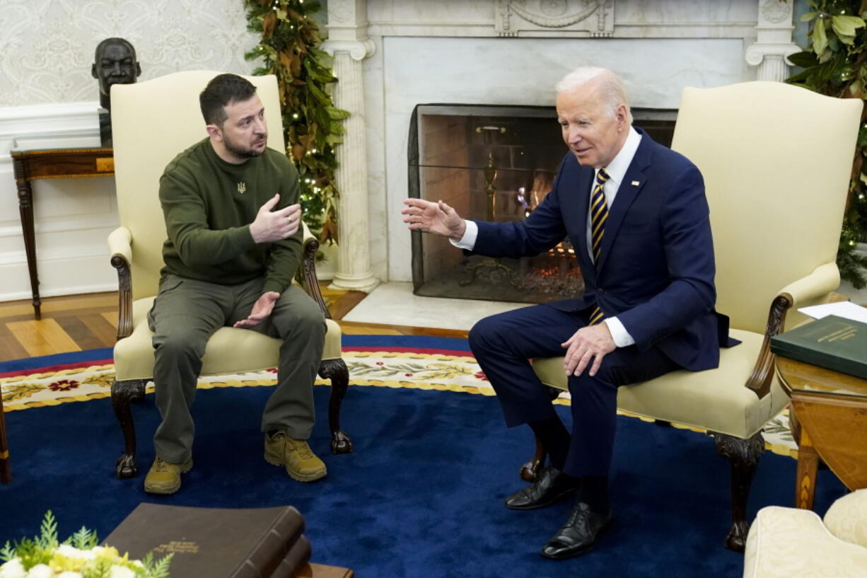 FILE - President Joe Biden speaks with Ukrainian President Volodymyr Zelenskyy as they meet in the Oval Office of the White House, Dec. 21, 2022, in Washington. One year ago, Biden braced for the worst as Russia massed troops in preparation to invade Ukraine. But as Russia's deadly invasion reaches the one year mark, Kyiv stands and Ukraine has exceeded even its own expectations.