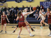 Keira Williams of Seton Catholic (1) takes a shot against Hoquiam’s Ashlinn Cady during Seton Catholic’s 56-45 win over Hoquiam in the 1A district girls basketball semifinal at Seton Catholic High School on Saturday, Feb. 11, 2023.