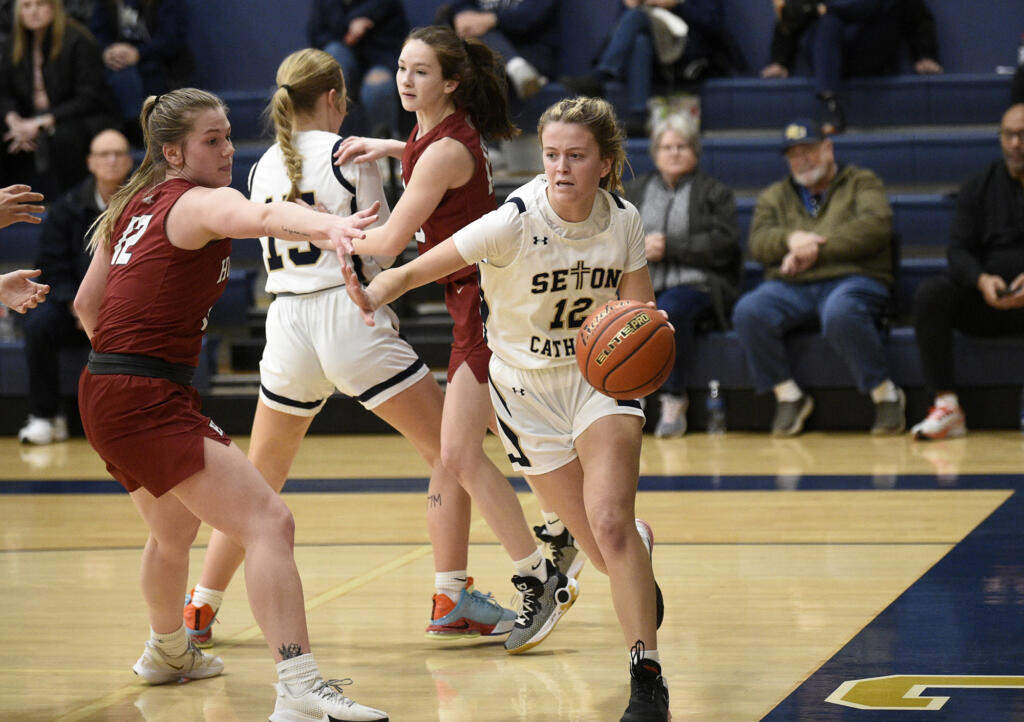 Anna Mooney of Seton Catholic (12) drives on the baseline during Seton Catholic’s 56-45 win over Hoquiam in the 1A district girls basketball semifinal at Seton Catholic High School on Saturday, Feb. 11, 2023.