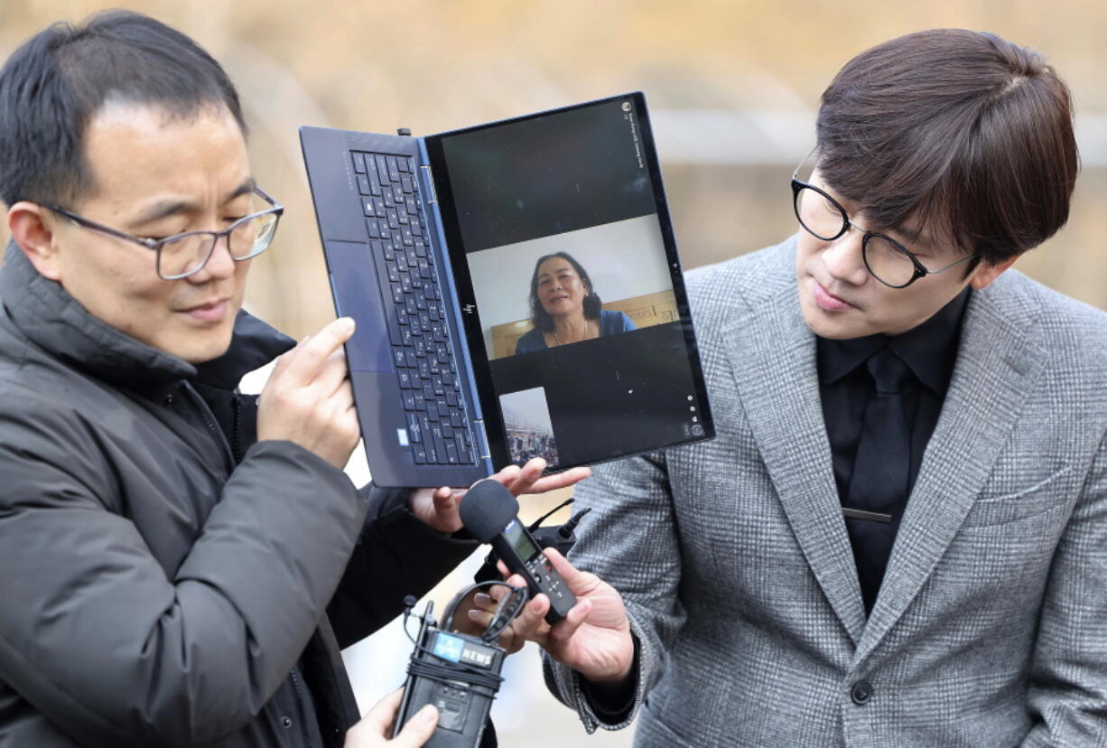 Vietnamese woman Nguyen Thi Thanh is seen on a computer monitor as she speaks outside the court at the Seoul Central District Court in Seoul, South Korea, Tuesday, Feb. 7, 2023. A South Korean court on Tuesday, Feb. 2023, ordered the government to pay 30 million won ($24,000) to a Vietnamese woman who survived a gunshot wound but lost several relatives when South Korean marines rampaged through her village during the Vietnam War in 1968.