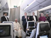 The Archbishop of Canterbury Justin Welby, right, Pope Francis,left, and the Moderator of the General Assembly of the Church of Scotland Iain Greenshields meet the journalists during an airborne press conference aboard the airplane directed to Rome, at the end of his pastoral visit to Congo and South Sudan, Sunday, Feb. 5, 2023.