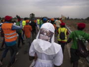 A sister wears headwear showing a picture of The Last Supper, as she and a group of the Catholic faithful from the town of Rumbek arrive after walking for more than a week to reach the capital for the visit of Pope Francis, in Juba, South Sudan Thursday, Feb. 2, 2023. Pope Francis is due to travel to South Sudan later this week on the second leg of a six-day trip that started in Congo, hoping to bring comfort and encouragement to two countries that have been riven by poverty, conflicts and what he calls a "colonialist mentality" that has exploited Africa for centuries.